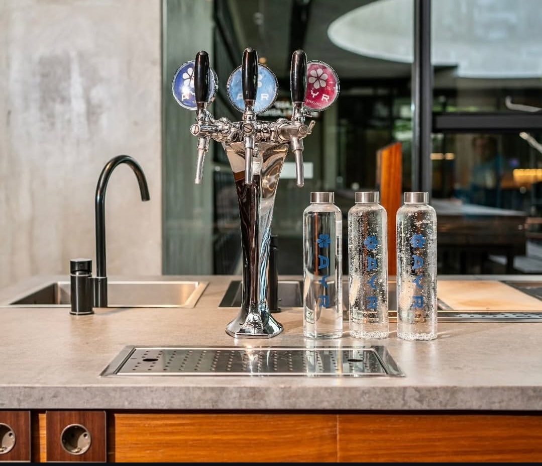 AYR Water on-site tap system with reusable glass bottles in a restaurant