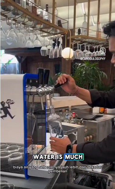 Amici Bali staff filling a reusable bottle from an AYR Water on-site dispensing system